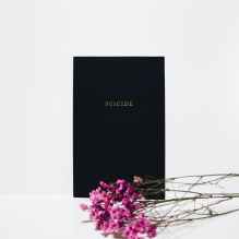 purple petaled flowers near black book